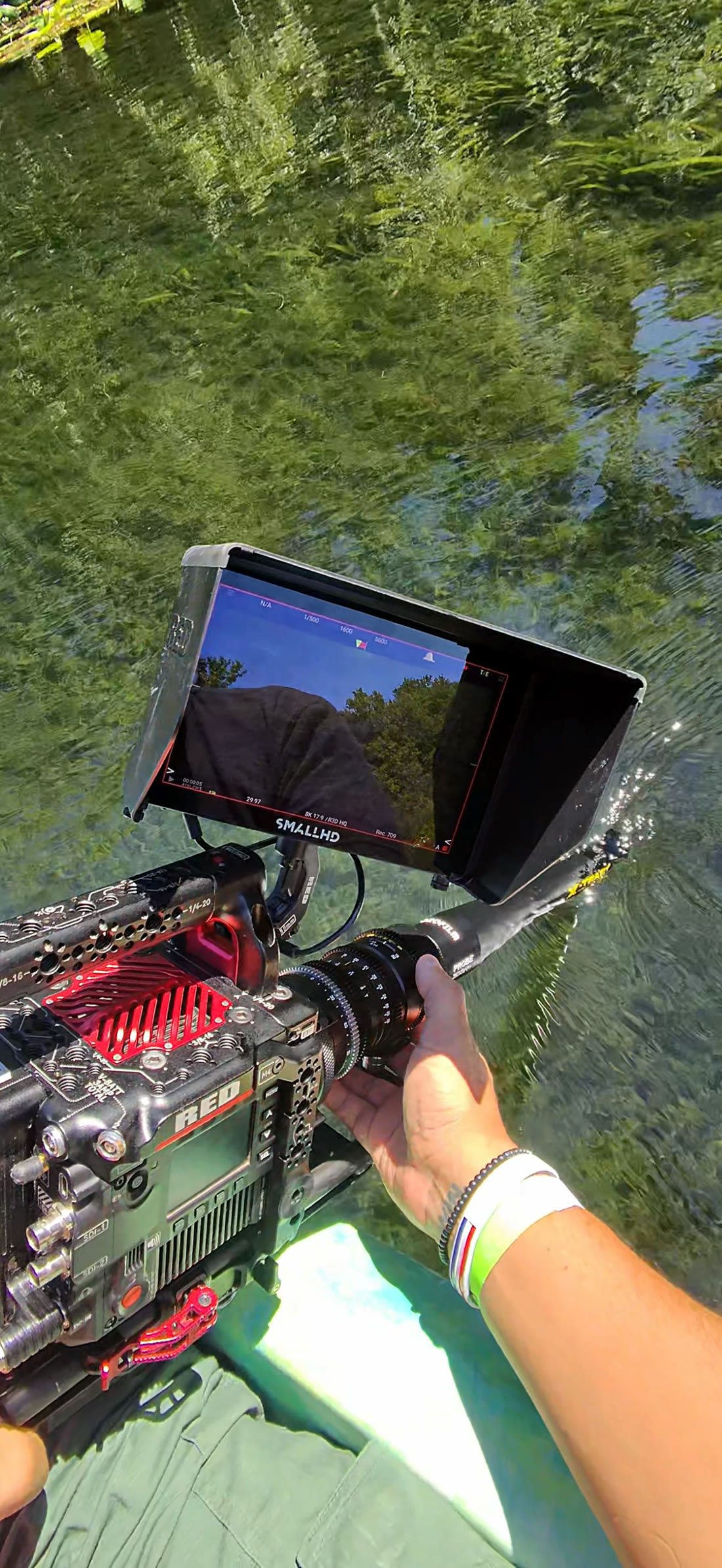 The camera held low over a clear Florida spring, the probe lens reaching down into the water, with a monitor above showing the shot.